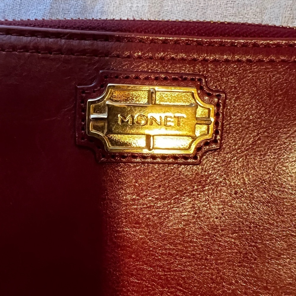 Vintage Monet zip around wallet with tassel on zipper. Maroon in color.